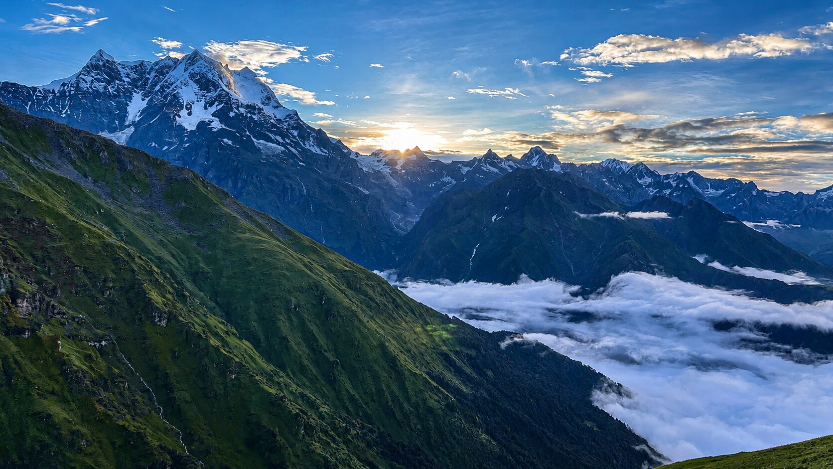 Sunrise over snow-capped Himalayan peaks with a sea of clouds below
